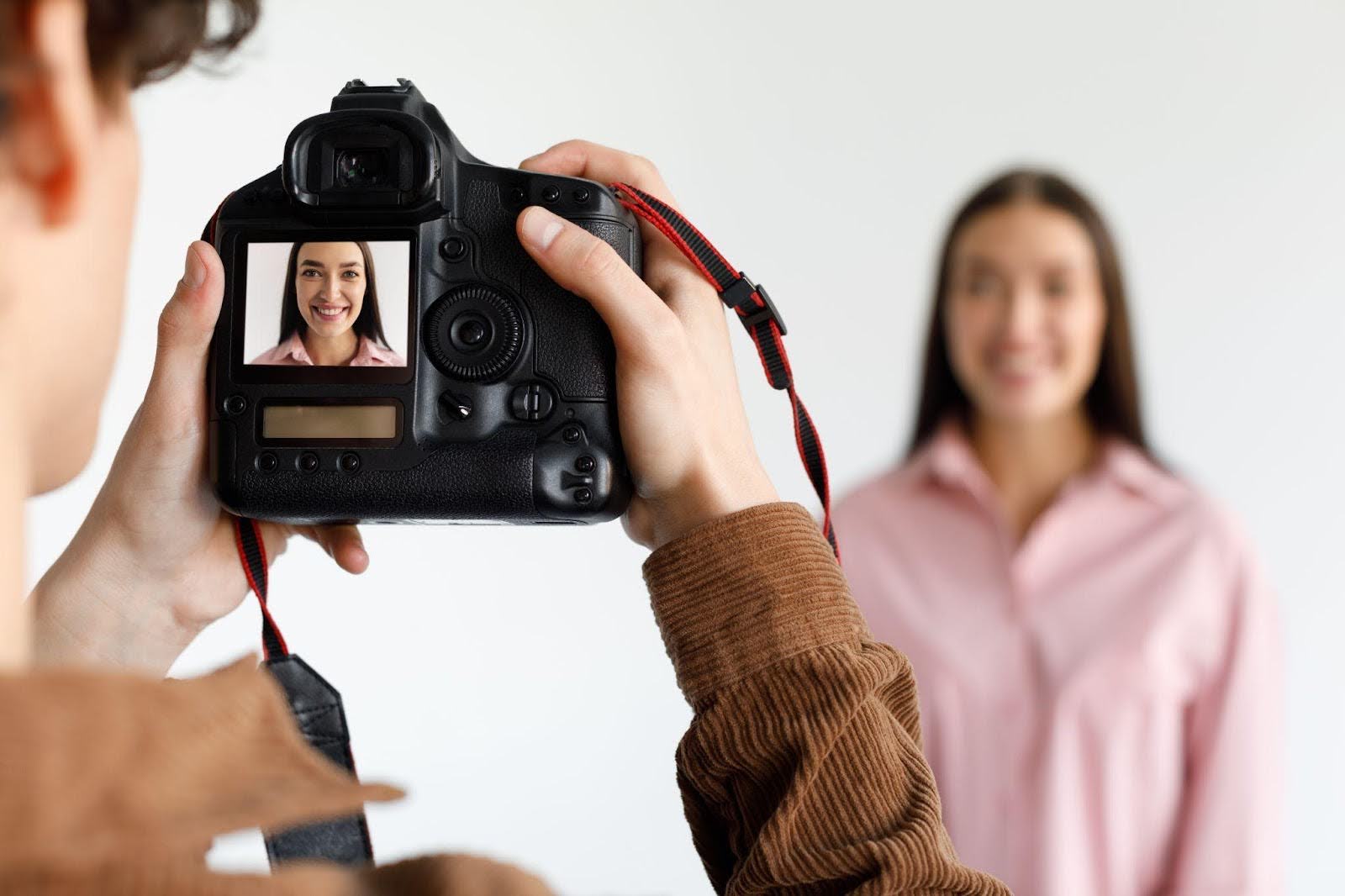 A woman photographs a man, showcasing their artistic interaction