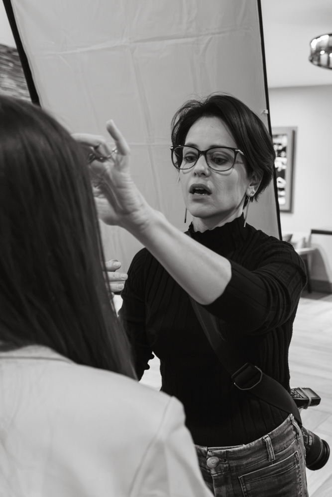 Jocelyn Gardiner directing a guest at an on-site headshot station during a corporate event in Park City, Utah