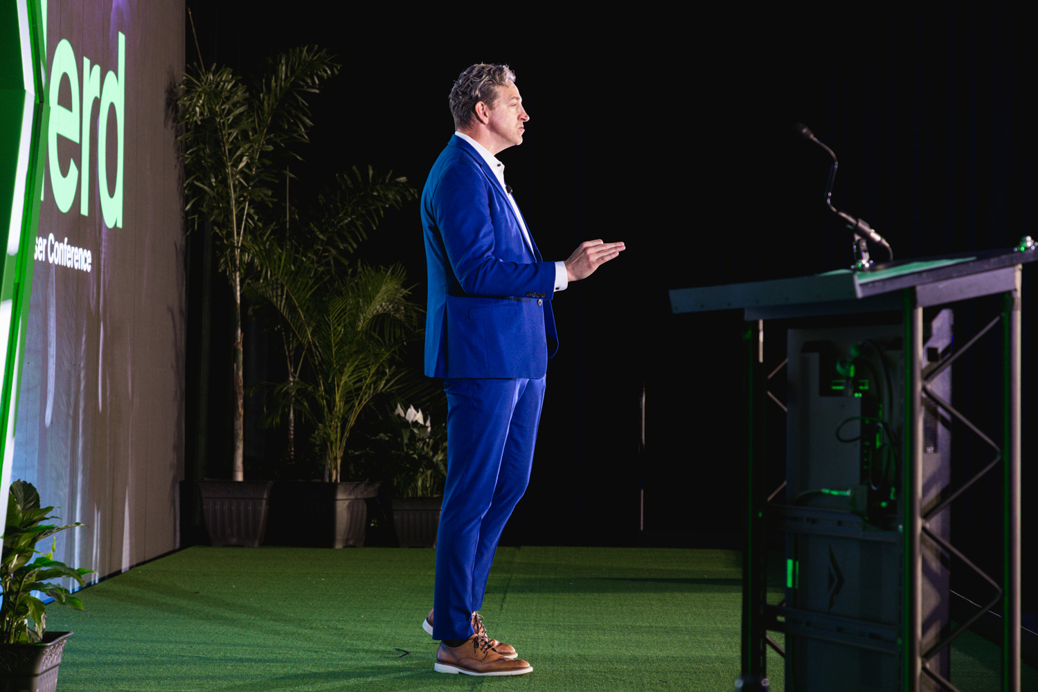 Keynote speaker presenting on the main stage at a user conference in Utah